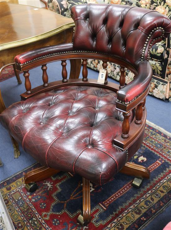 A mahogany captains chair covered in buttoned hide and a Victorian mahogany side chair